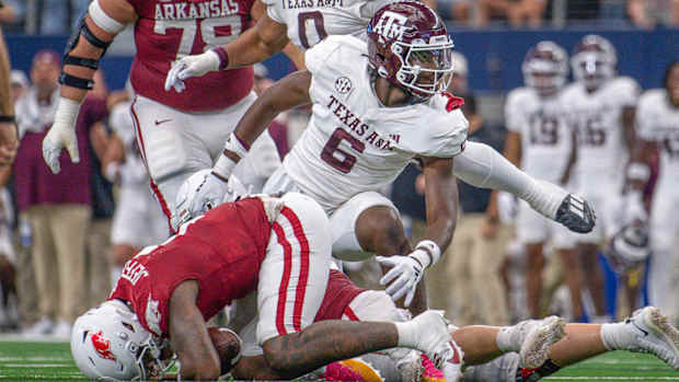 Razorbacks quarterback on ground again in game with Texas A&M after sack by Enai White